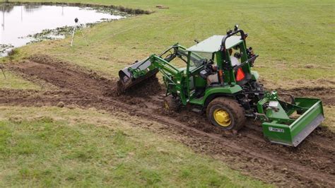 digging a swale with a skid steer|How To Make Drainage Swale .